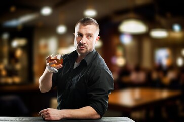 Handsome male barman with alcohol drink