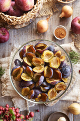 Fresh pitted plums, apples, ginger, onion and spices - preparation of chutney - homemade relish