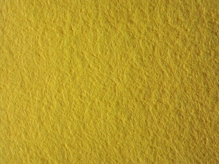 The textured surface is yellow, light green, pistachio color, herbal color as a background. Felt. High quality photo