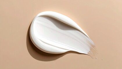 Creamy, white cosmetic smear on beige backdrop