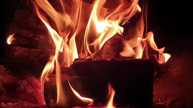 fire burns at night in a fire pit