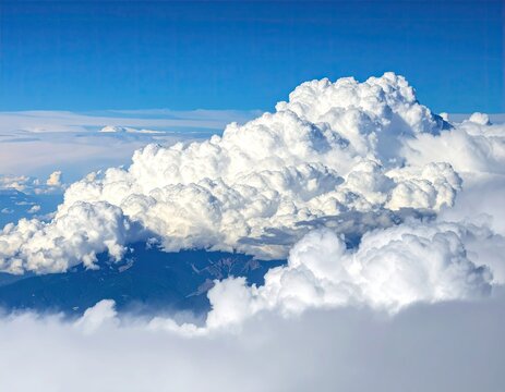 High-altitude view of fluffy clouds over mountain peaks