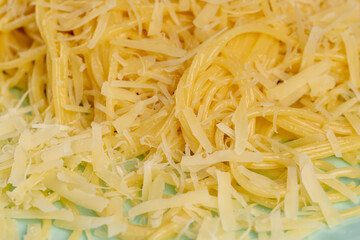 boiled soft delicious spaghetti with the addition of grated hard cheese, details of thin boiled spaghetti cooked with water with the addition of butter and cheese