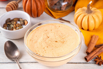  Pumpkin Spice Greek Yogurt in glass bowl, with spices, cinnamon, healthy autumn snack with traditional fall season taste, protein and calcium source