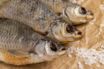 white salt and dried fish for long-term storage by dehydrating whole fish in the sun, dehydrated and dried fish ready for human consumption, sprinkled with white salt