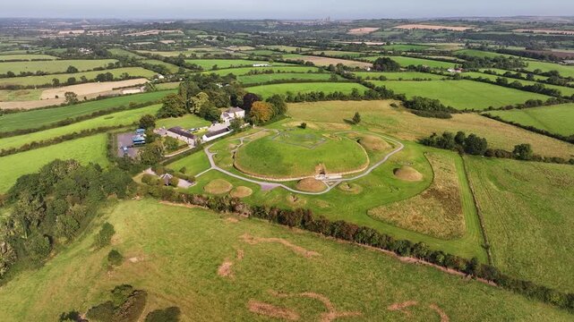 Aerial pull back from passage tomb entrance of Knowth megalithic monument, Ireland history.