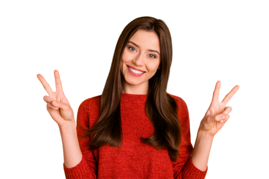 Portrait of positive cheerful youth girl have fun enjoy her free time autumn holidays make v-signs wear red sweater isolated over yellow color background