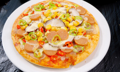 Delicious Ham and Mushroom Pizza with Corn and Peppers on White Plate