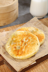 Traditional Asian Pan-Fried Dumplings or Savory Pancakes on Wooden Kitchen Table