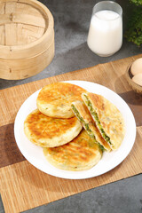 Asian Stuffed Pancakes with Green Vegetable Filling and Milk Traditional Breakfast Meal