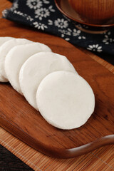 Handmade White Glutinous Rice Cakes Sliced on Wooden Board Traditional Asian Dessert