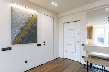A Modern Entryway Featuring Stylish Art and a Beautifully Contemporary Design Aesthetic