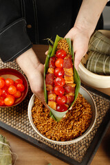 Handmade Asian Rice Tamale with Salted Egg Yolk and Meat Filling in Banana Leaf Wrapper