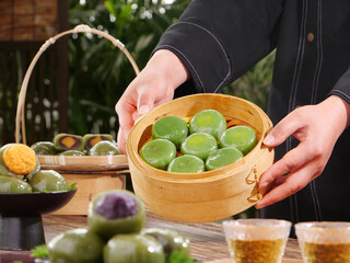 Traditional Green Dim Sum Dumplings in Bamboo Steamer - Handmade Asian Cuisine with Mugwort and Colorful Varieties