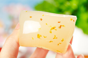 Osmanthus Rice Cake Slice with Golden Flower Petals - Traditional Asian Sweet Dessert Confection
