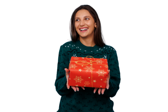 Happy woman in christmas sweater celebrating holiday, smiling, holding red gift box with snowflakes, transparent background - Powered by Adobe
