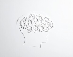 White paper cutout of a head with intricate gears, suggesting cognitive function