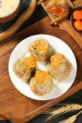 Shumai Dumplings with Salted Egg Yolk Floss Topping - Traditional Chinese Dim Sum on Bamboo Tray
