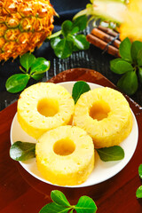 Fresh Sweet Pineapple Rings with Mint Leaves on Wooden Table - Tropical Fruit Slices