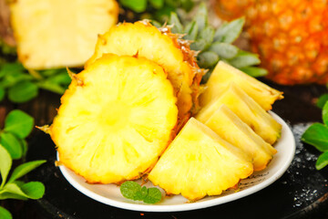 Fresh Pineapple Slices and Torn Pieces from Zhanjiang - Sweet Tropical Fruit with Yellow Flesh on White Plate