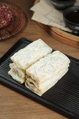 Handmade Vegetarian Spring Rolls with Fresh Vegetables on Black Serving Plate