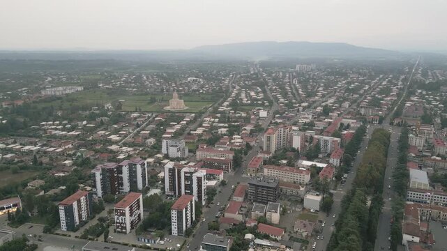Drone view new and old apartment blocks in Zugdidi residential district with cathedral background &mdash; concepts: real estate, housing, urban growth, investment, development, infrastructure, lifestyle