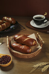 Traditional German Pretzel Bread Rolls with Coffee - Handmade Lye Bread Breakfast Setup on Wooden Table