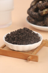 Crushed Chocolate Cookie Crumbs in Bowl Ready for Baking and Dessert Making