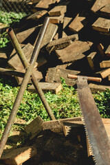 Old hand saw on wooden logs outdoors