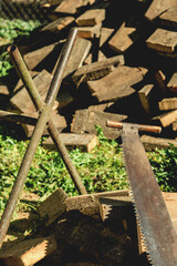 Old hand saw on wooden logs outdoors