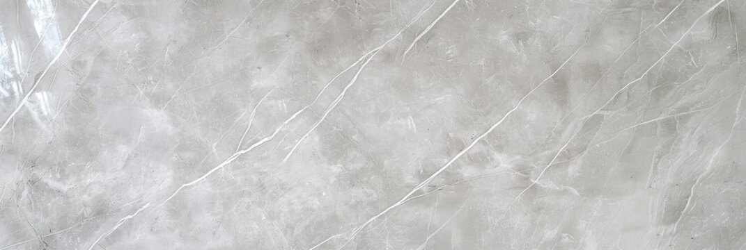 A close-up shot reveals a light gray surface, possibly stone or a similar material, featuring a subtle veined pattern. The texture appears smooth with variations in shading