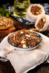 Five Spice Collection with Cinnamon Star Anise Hot Spices in Bowls and Bags on Wooden Table