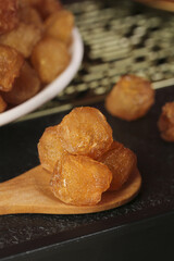 Dried fruits and dumplings on wooden spoon - Asian cuisine and healthy snacks