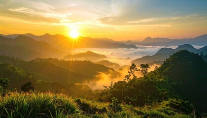 Sunrise over misty mountain range. Lush green hills and valleys bathed in golden light