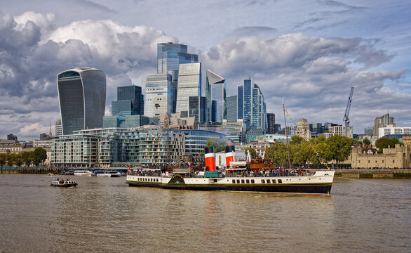 New and Old - The City of London and the Paddle Steamer Waverley on The River Thames in London UK