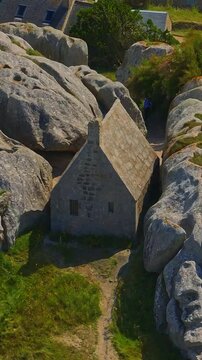  France, Meneham, 26 February 2025: Aerial view of an ancient stone house in the rocks