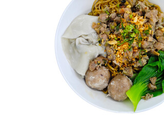 Top view of Indonesian chicken noodle dish Mie Ayam Bakso Pangsit served in a white bowl, isolated on white.