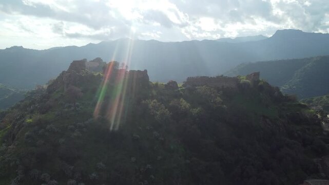 Aerial drone footage of Savoca in Sicily, the historic village famous for The Godfather, showing dramatic clouds, peaceful streets, traditional architecture, and surrounding nature.