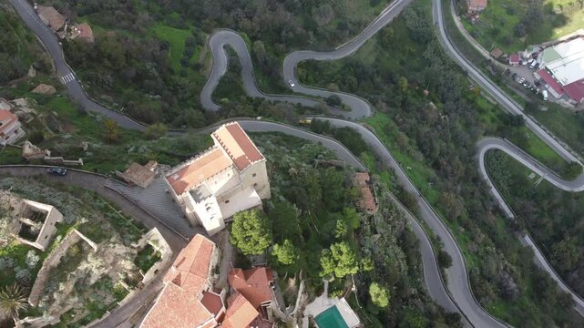 Aerial drone footage of Savoca in Sicily, the historic village famous for The Godfather, showing dramatic clouds, peaceful streets, traditional architecture, and surrounding nature.