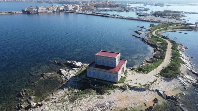 Aerial drone footage of Trapani, highlighting the seaside town, historic center, harbor, and stunning Mediterranean coastline under clear sunny weather