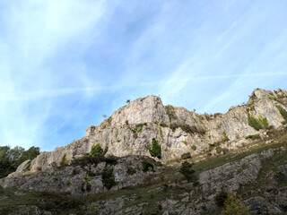 Tall cliff face jagged rocks and stone gorge mountins with clear sky in the UK landscape