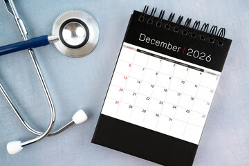 December 2026 calendar and stethoscope, Medical appointment schedule to check up concept.