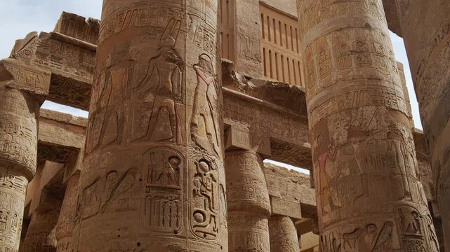 Ancient egyptian hieroglyphs carved on open papyrus umbel capitals. The Karnak Temple Complex, Luxor, Upper Egypt. UNESCO World Heritage Site
