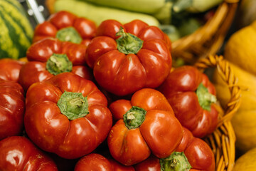 A beautiful display of vibrant red heirloom tomatoes elegantly arranged in a charming rustic market basket