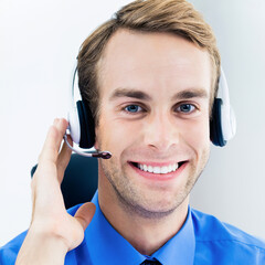 Call Center Service. Face portrait - happy smile customer support callcenter sale agent. Phone operator business man businessman in microphone headset, blue shirt at office workplace. Square image