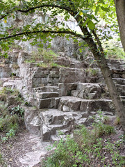 Tall cliff face jagged rocks and stone gorge mountins with clear sky in the UK landscape