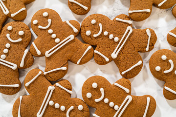 Decorating Gingerbread Man Cookies with Royal Icing for Festive Occasions