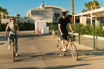 Young Couple Cycling to Yacht at Marina