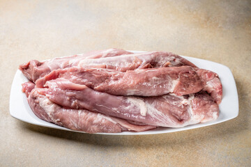 Raw pork tenderloin fillets on plate