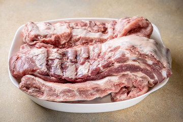 Fototapeta premium Raw pork ribs on white plate